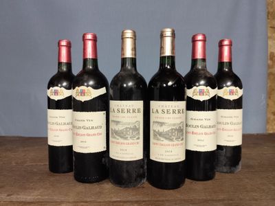 six bottles of red wine are lined up on a wooden table