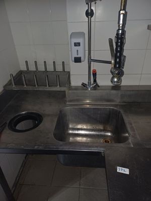 un lavabo et un robinet dans des toilettes publiques