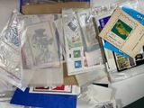 many different types of stamps and envelopes on the table