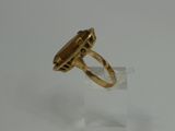 an image of a gold ring with a stone in the middle