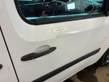 a small white van with a door handle and a sticker on the side of it