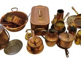 many different types of copper pots and pans on the table