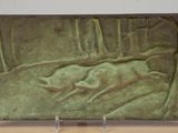 sculpture of a woman laying down on a bed in a forest
