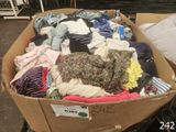 a cardboard box full of clothes on display in a store