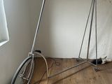 a bike that is sitting on a stand in the corner of a room