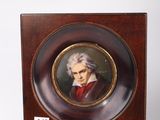portrait of a man in a red coat and white hair in a wooden frame