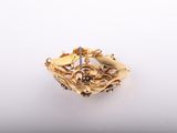 a close up of a gold ring on a white surface