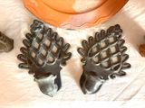 two metal deer heads sitting on a table next to a pumpkin