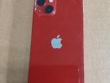 a red iphone with a broken screen sitting on top of a table