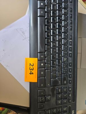 a computer keyboard sitting on top of a desk next to a computer monitor