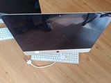 a computer monitor and keyboard sitting on a wooden floor
