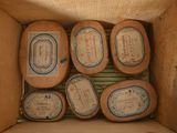 several pieces of cheese in a cardboard box with labels on them