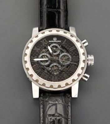 a close up of a watch on a black leather strap