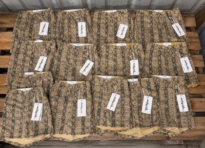 a bunch of bags of food sitting on top of a wooden pallet