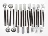 a lot of forks, spoons, and spoons on the table