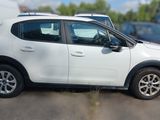 a picture of a white car parked in a parking lot