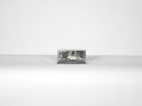 a small object that is sitting on a white surface