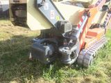 a machine that is sitting in the grass on the ground