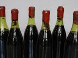 six bottles of wine are lined up in a row