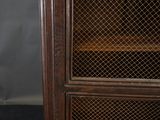 an old wooden cabinet with a glass door