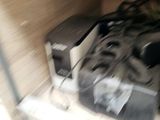 a pile of electronics on a shelf in a room