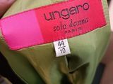 a person holding a green umbrella with a pink label on it