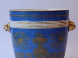 an image of a blue and gold vase with handles on a white background