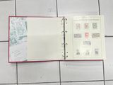 an open book with stamps on it sitting on a tiled floor