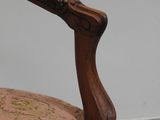 a wooden chair with a brown upholstered seat