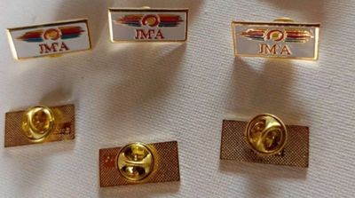 four lapel pins with the name of the air force on them