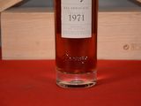 a bottle of whiskey sitting on a table next to a wooden box