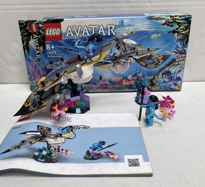 a box of legos and a book on a table