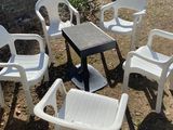 four chairs and a table in the middle of the yard