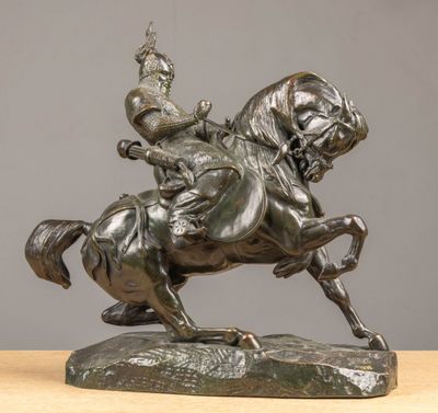 bronze statue of a man on a horse with a crown on his head