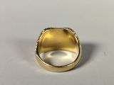 a close up of a gold ring on a white surface