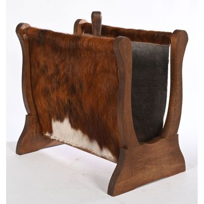 brown and white cowhide magazine rack with wooden legs