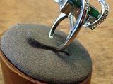 a ring that is sitting on top of a wooden stand