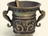 une tasse en métal munie d'une anse et contenant une cuillère
