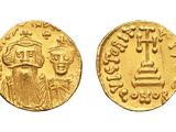a gold coin with an image of a man and a woman on it