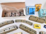 a box of train tracks and a box of books on the table
