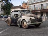 an old car that is sitting in the middle of a parking lot