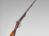 a rifle with a wooden barrel and a wooden handle