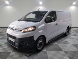 the white van is parked in a large room with a checkered floor