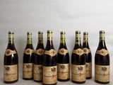 six bottles of wine lined up in a row on a table
