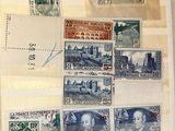 an open book with a bunch of stamps on it sitting on top of a table