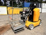 a small yellow machine that is parked in the dirt