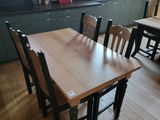 une table et des chaises en bois dans une cuisine dotée d'une lucarne