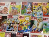 a lot of comic books on the table together
