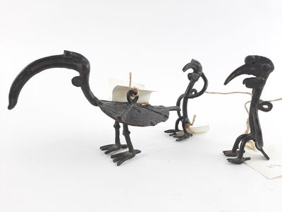 three metal birds that are standing next to each other