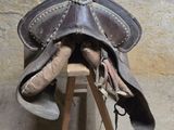 une selle de cheval posée sur un support en bois